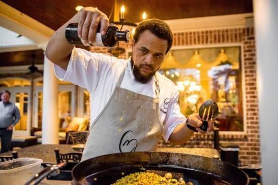 Chef Michael Gabriel pouring liquid into pan
